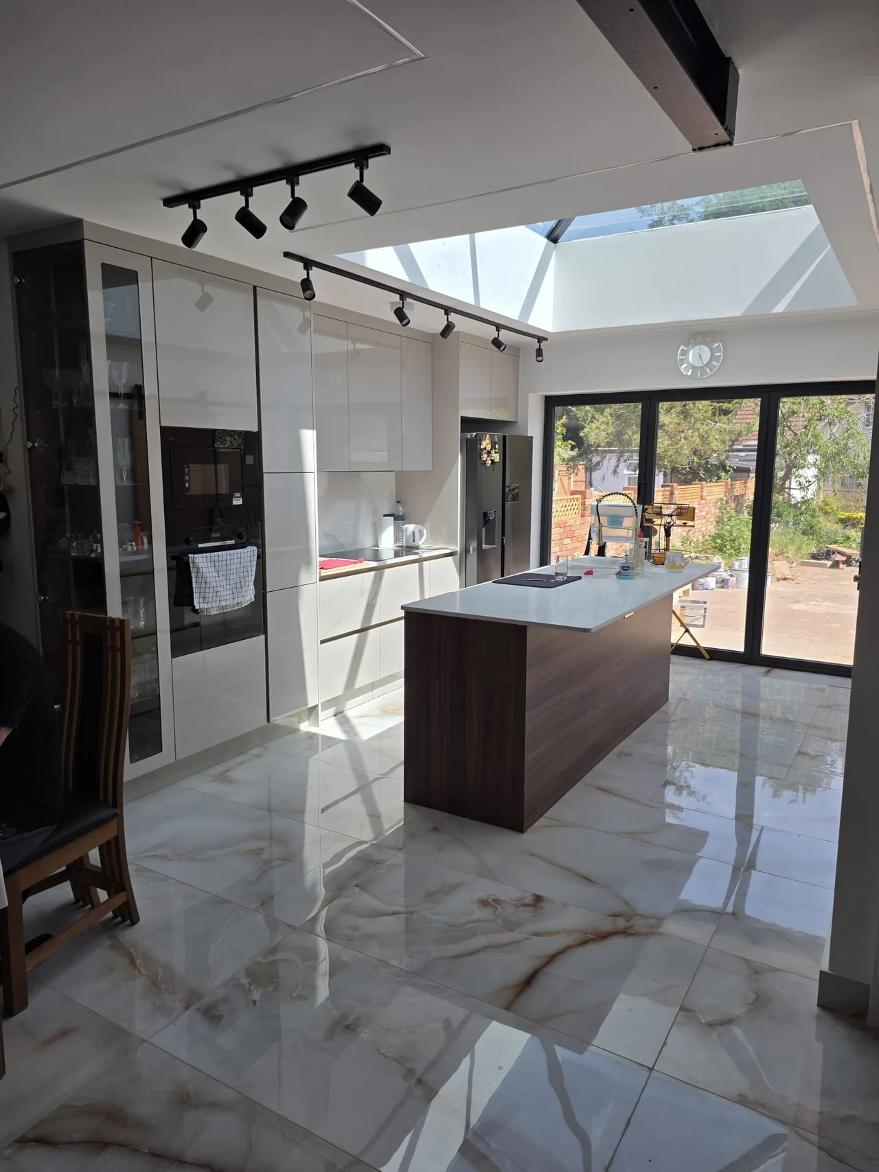 Kitchen and living space with roof glazing and garden-facing doors