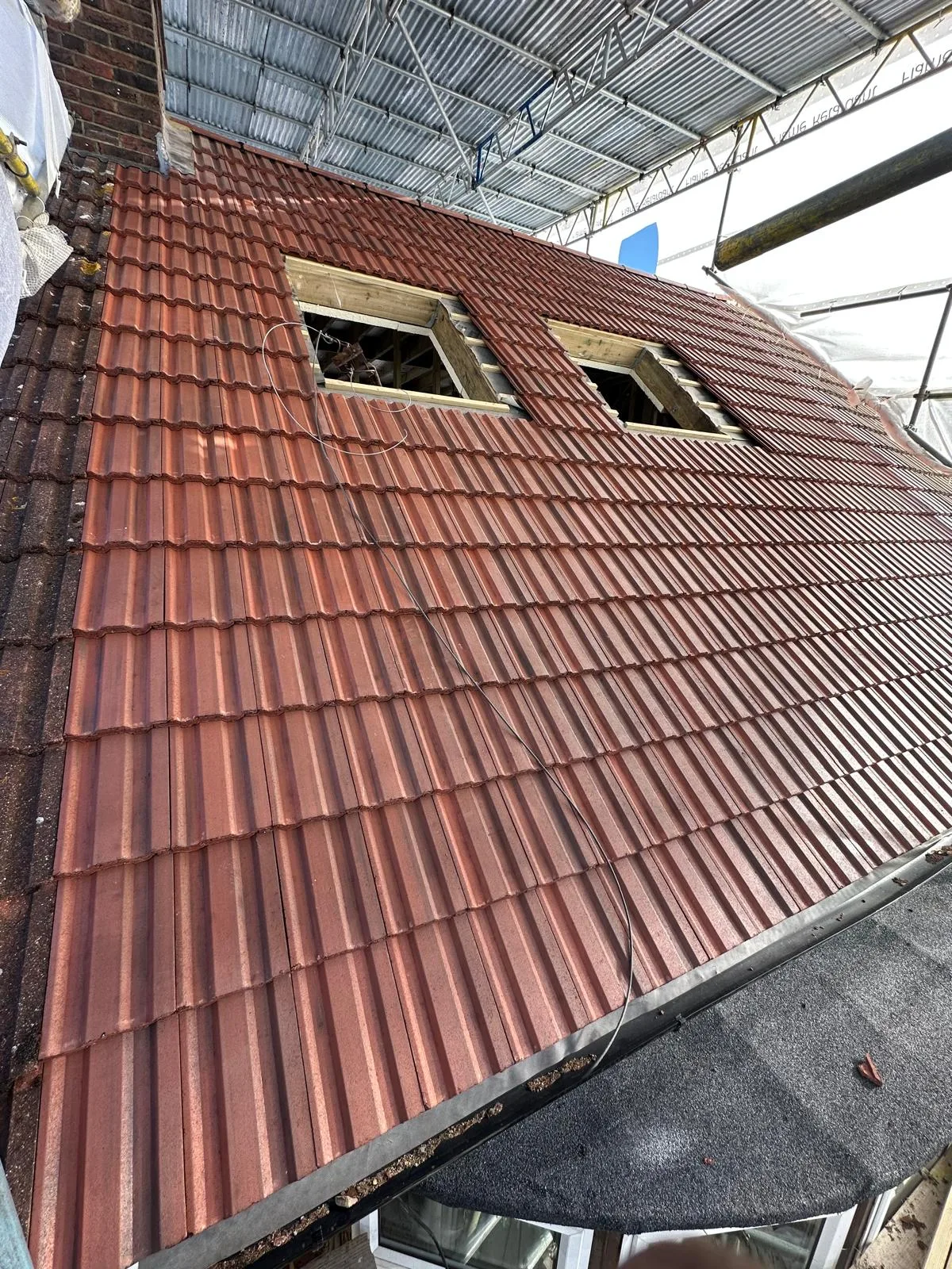 Tiled roof and rooflight openings with scaffolding
